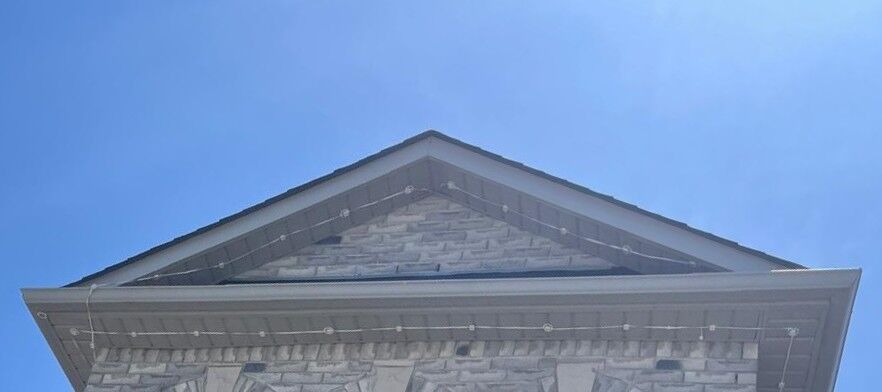 sagging wires stone pediment closeup